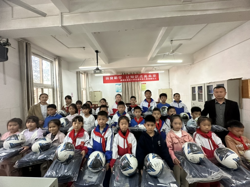 Students at Jiujiang Ailian Primary School with donated soccer balls and activity supplies.