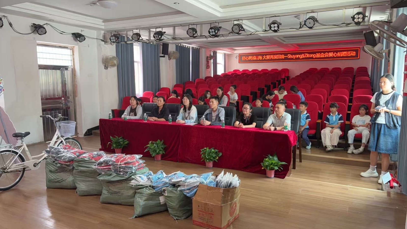 Donated school uniforms and student support supplies prepared at Xinhe Town Central Primary School.